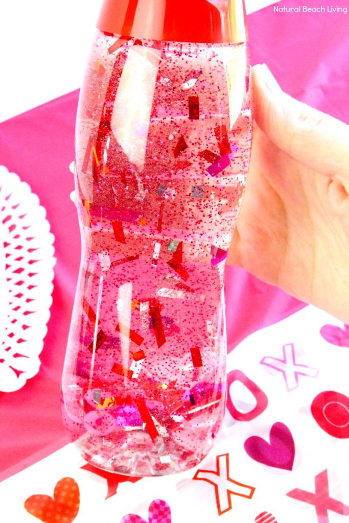 How to Make Valentines Sensory Bottles Kids Love, Valentine's Day Sensory Bottles are perfect for any home or classroom activity, Homemade sensory bottles make a great addition to any Science table, Calm down bottles, DIY Sensory Bottle, Easy sensory activity for preschoolers and Toddlers, Valentine's Day craft for kids, #sensoryplay #Valentinesdaycrafts #sensorytoys #sensoryprocessingdisorder 